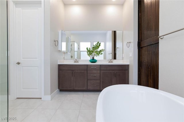 bathroom featuring vanity, a tub to relax in, and tile patterned floors