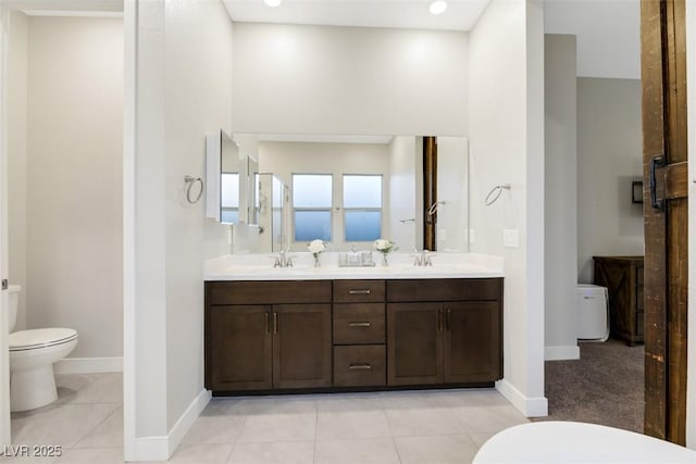 bathroom featuring tile patterned flooring, vanity, and toilet