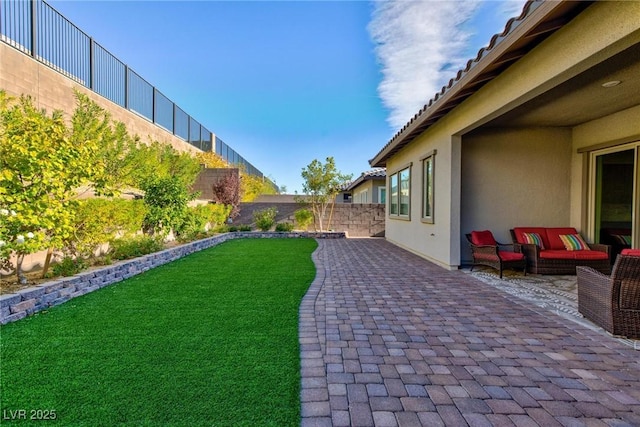 view of yard with an outdoor living space and a patio area