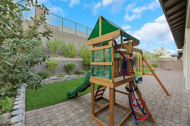 view of playground with a patio