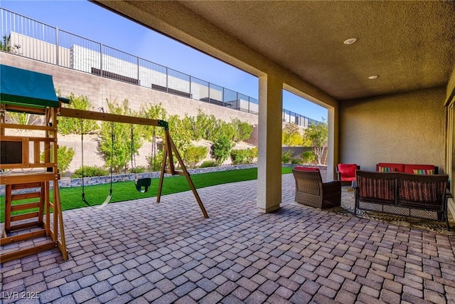 view of patio / terrace featuring an outdoor living space and a playground