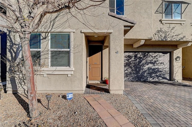 entrance to property featuring stucco siding