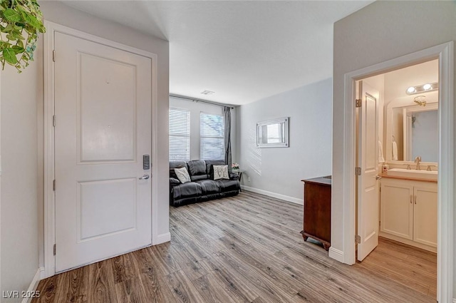 interior space with light wood finished floors and baseboards