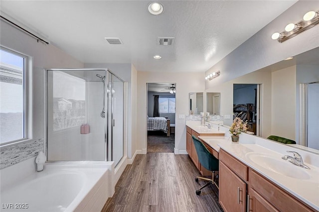 full bath featuring ensuite bath, a sink, visible vents, and a shower stall