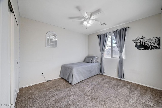 unfurnished bedroom with carpet, visible vents, ceiling fan, and baseboards