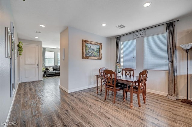 dining room with recessed lighting, baseboards, visible vents, and light wood finished floors