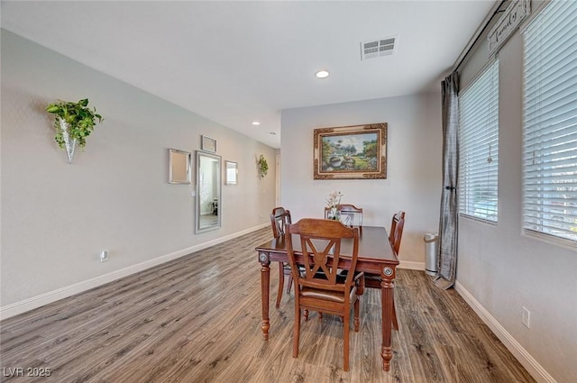 dining room with recessed lighting, visible vents, baseboards, and wood finished floors