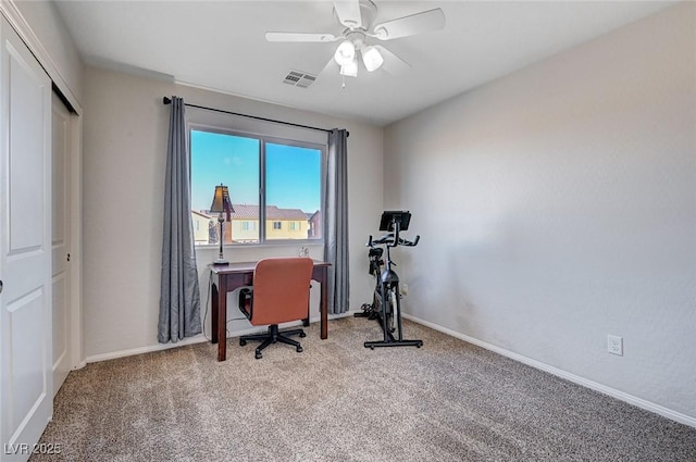 carpeted home office featuring a ceiling fan, visible vents, and baseboards