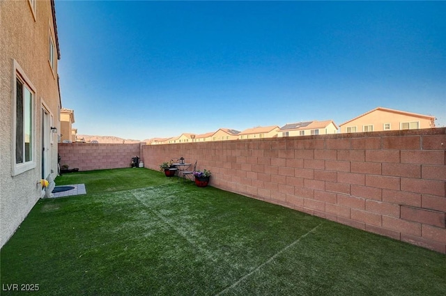 view of yard with a fenced backyard