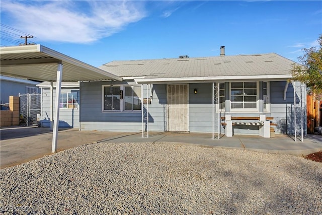 ranch-style home featuring a carport