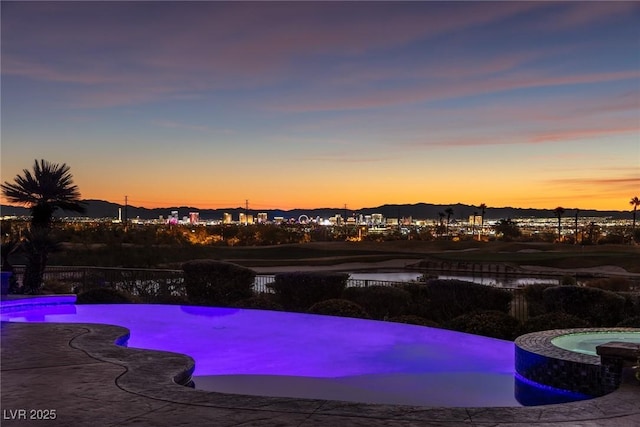 view of pool at dusk