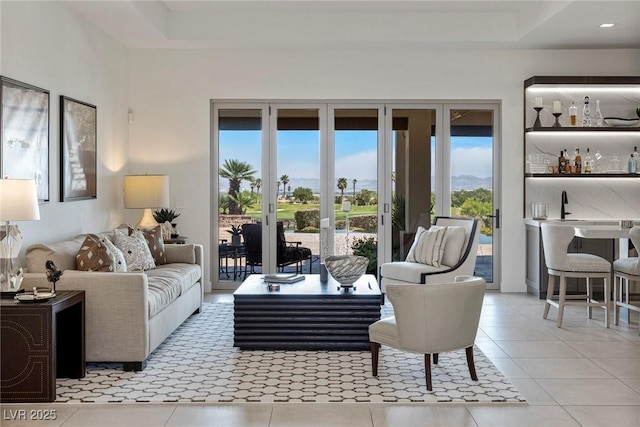 living room featuring light tile patterned floors and bar