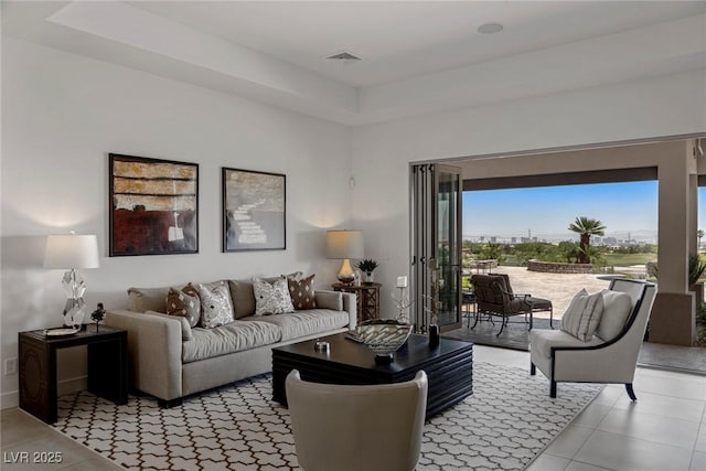 tiled living room with a raised ceiling