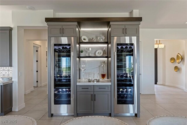 bar featuring gray cabinetry and wine cooler