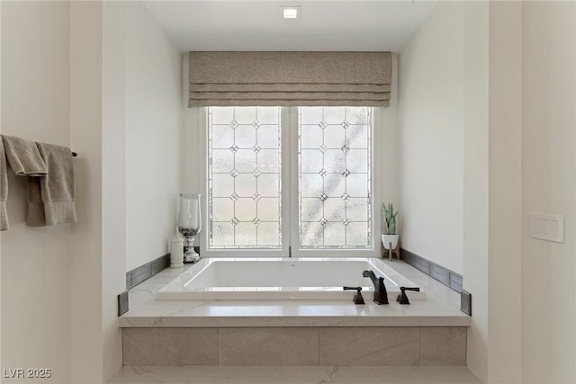 bathroom featuring tiled bath