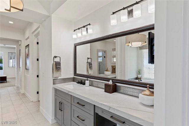 bathroom featuring tile patterned flooring, vanity, and a wealth of natural light