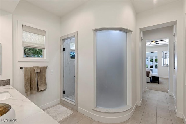 bathroom featuring tile patterned flooring, vanity, an enclosed shower, and ceiling fan