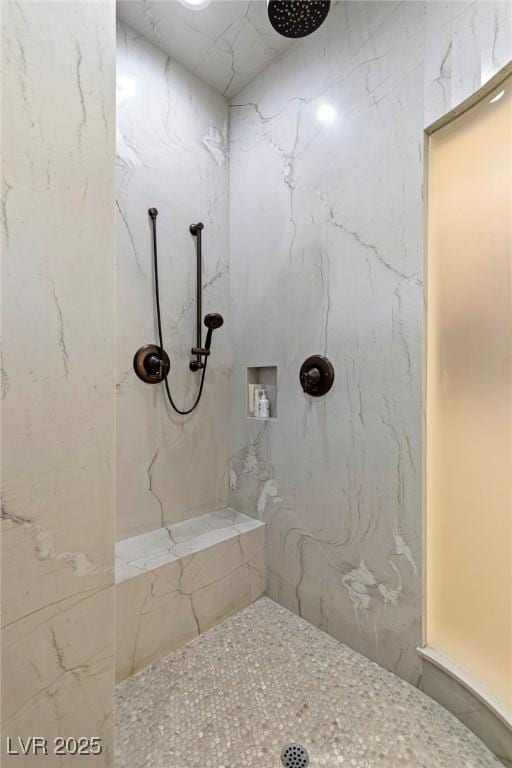 bathroom with a tile shower