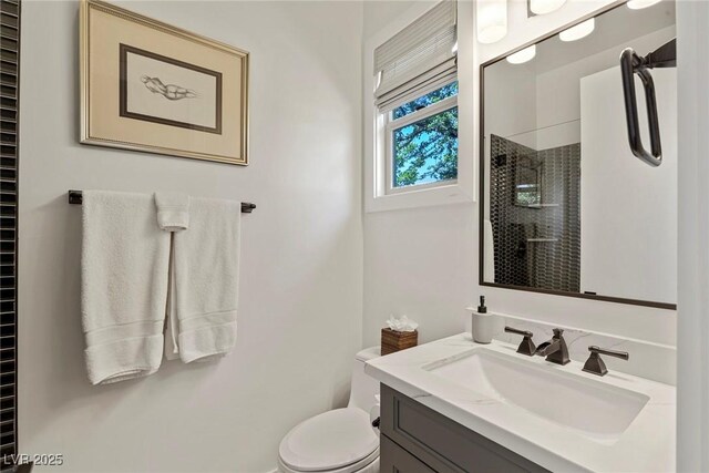 bathroom with vanity, toilet, and an enclosed shower