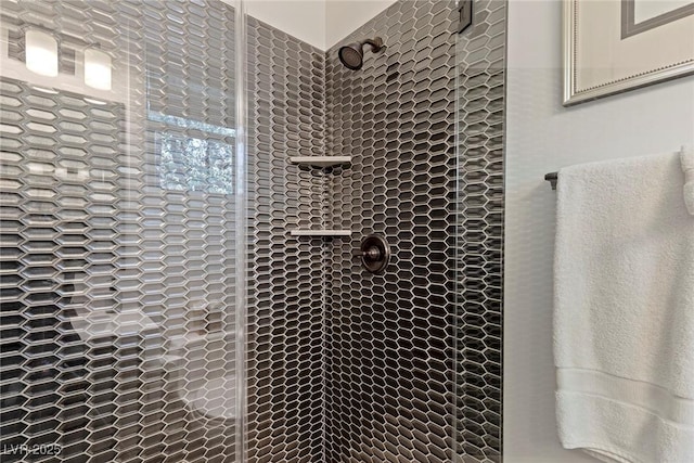 bathroom with a tile shower