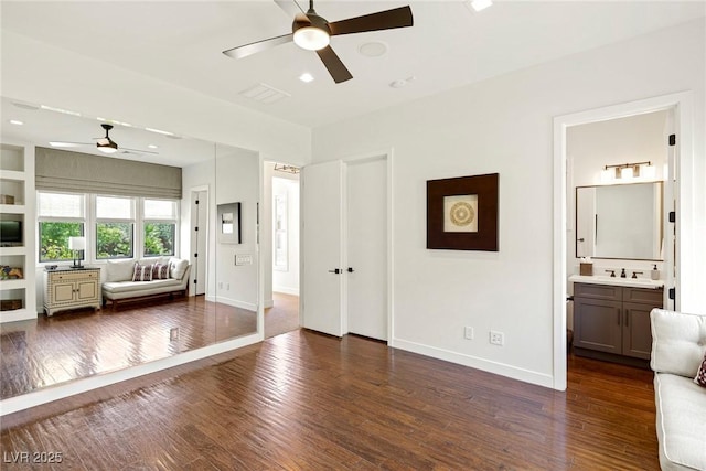 interior space with ceiling fan, sink, and dark hardwood / wood-style floors