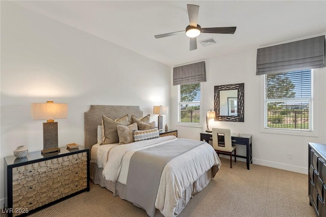 bedroom with ceiling fan and light carpet