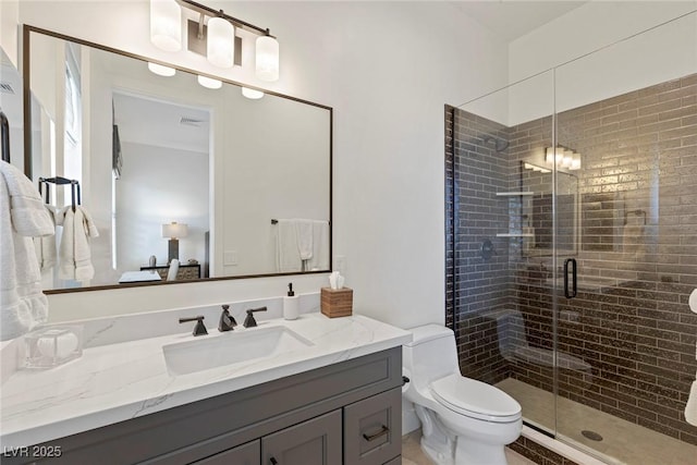 bathroom with toilet, vanity, and walk in shower