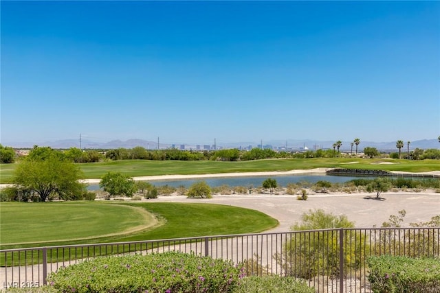 surrounding community with a water view and a lawn