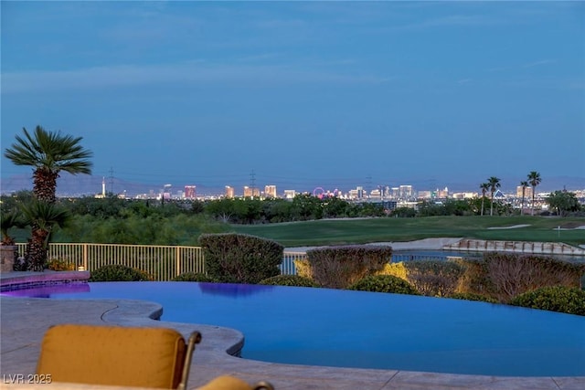 view of pool at dusk