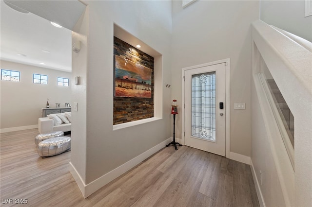 foyer entrance with light hardwood / wood-style floors