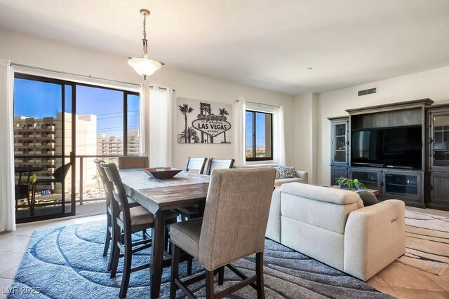 dining space featuring light tile patterned floors