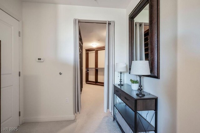 hallway featuring light colored carpet