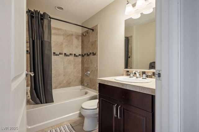 full bathroom featuring tile patterned floors, vanity, toilet, and shower / bath combo