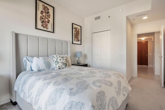 bedroom with light colored carpet and a closet