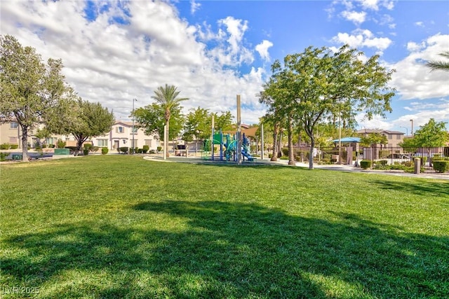 view of home's community featuring a yard and a playground