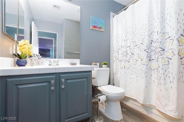 full bathroom featuring shower / bath combination with curtain, wood-type flooring, toilet, and vanity