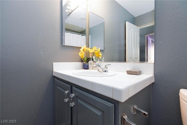 bathroom with vanity and toilet