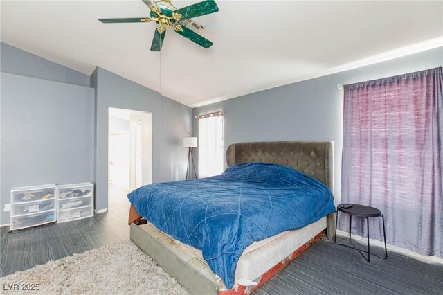 bedroom with lofted ceiling, connected bathroom, and ceiling fan