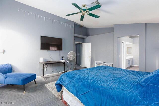 bedroom with lofted ceiling, connected bathroom, and ceiling fan