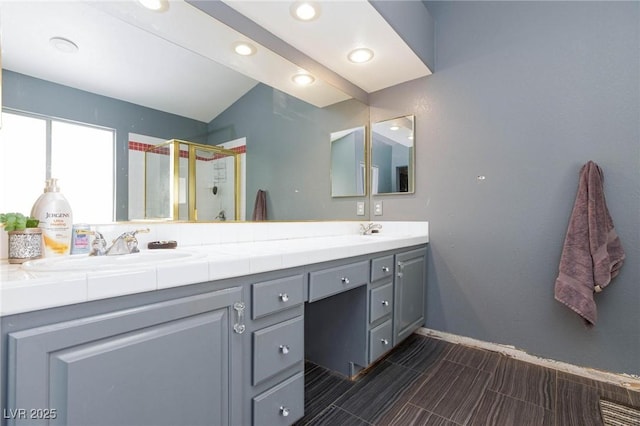 bathroom featuring vanity and a shower with shower door