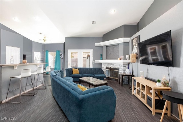 living room featuring ceiling fan and a fireplace