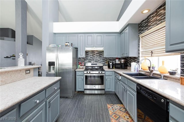 kitchen featuring stainless steel appliances, sink, backsplash, and gray cabinets