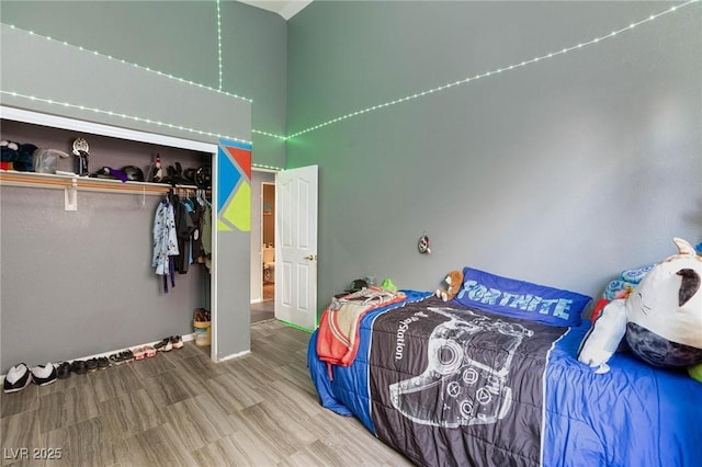 bedroom featuring wood-type flooring and a closet