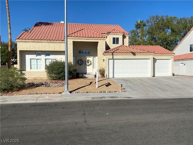 mediterranean / spanish-style home featuring a garage