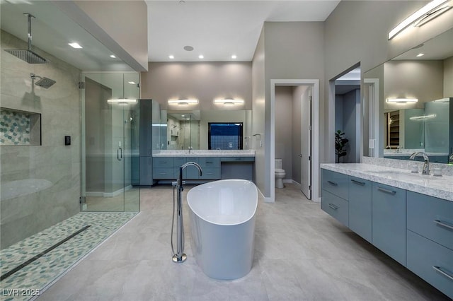 full bathroom featuring separate shower and tub, a towering ceiling, vanity, and toilet