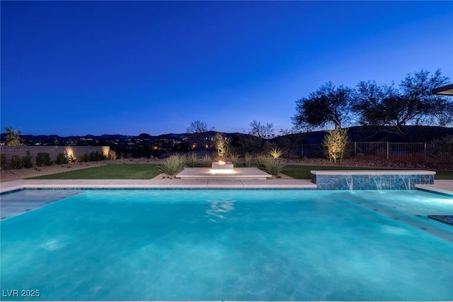 pool at dusk with pool water feature