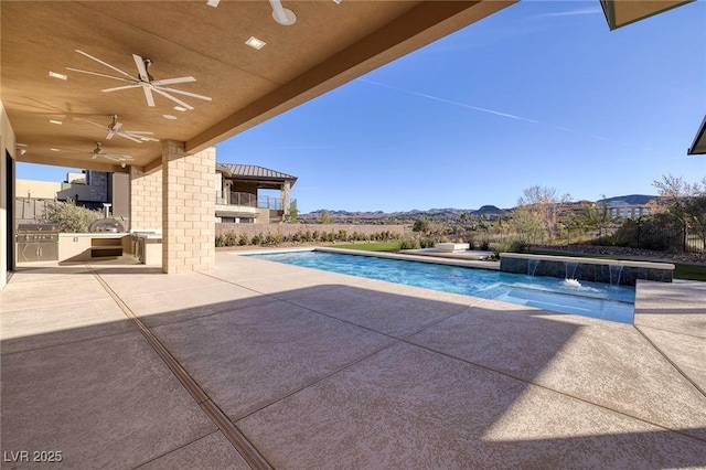 view of swimming pool with pool water feature, ceiling fan, area for grilling, and a patio