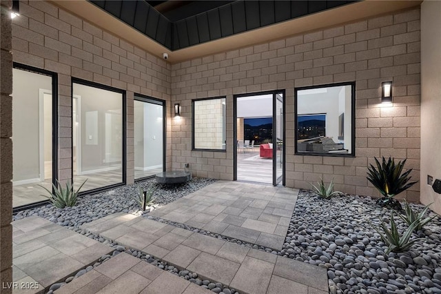 property entrance featuring a patio area