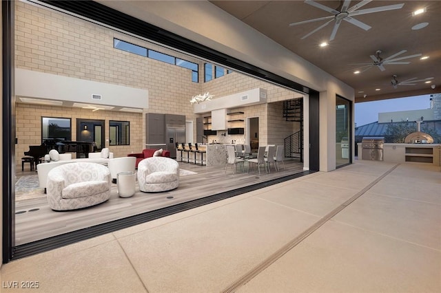 view of patio featuring area for grilling and ceiling fan