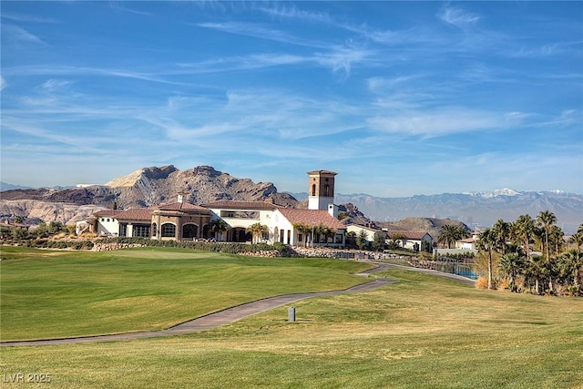 view of home's community featuring a yard, a mountain view, and view of golf course